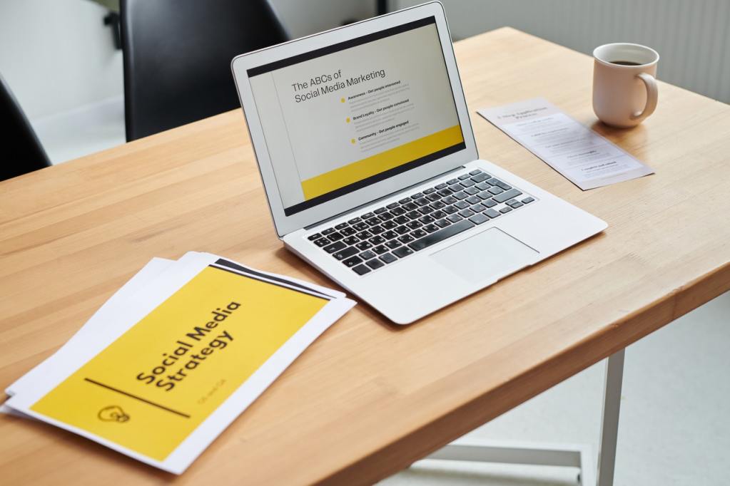 laptop and document that says "social media strategy"